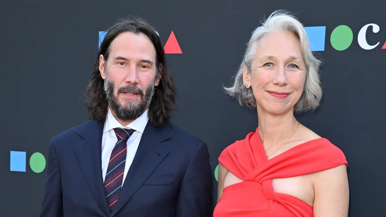 A medium close-up shot of Keanu Reeves and Alexandra Grant posing together at the MOCA Gala.